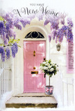 This graceful entranceway, easily imagined on a peaceful Hither Green sidestreet, tells a story of fresh starts through its gentle colours and thoughtful floral styling. The main focus is a pale pink front door, painted in a slightly weathered, pastel hue that seems to glow softly against the surrounding whitewashed brick. The door feels inviting and personal, like the sort of home you might pass on your way to Manor House Gardens. Overhead, luxuriant wisteria spills down in long, tumbling garlands, its clusters of lavender and lilac blossoms creating a dreamy canopy. The tiny petals catch the light, giving the impression of movement and fragrance, while slender green leaves and twisting vines break up the soft purples with natural texture. Sitting squarely on the doorstep is a vintage-inspired grey metal bucket, filled almost to overflowing with plush white and cream roses. The roses are open and full, their velvety petals arranged in concentric layers, as if each bloom holds a quiet secret of celebration. Threads of soft green foliage weave among the flowers, adding height and contrast and echoing the greenery of local gardens. Around the base of the bucket, a pale pink satin ribbon is tied in a relaxed bow, its sheen catching the light and picking up the blush tones of the door. The atmosphere is hushed yet hopeful, as though the flowers have just been placed there to greet someone returning from the train or from errands along Hither Green Lane. It is a scene that lends itself perfectly to a housewarming or congratulations card, capturing the feeling of arriving at a new address in Hither Green to find not only keys and fresh paint, but a doorway already filled with warmth, scent, and welcome.